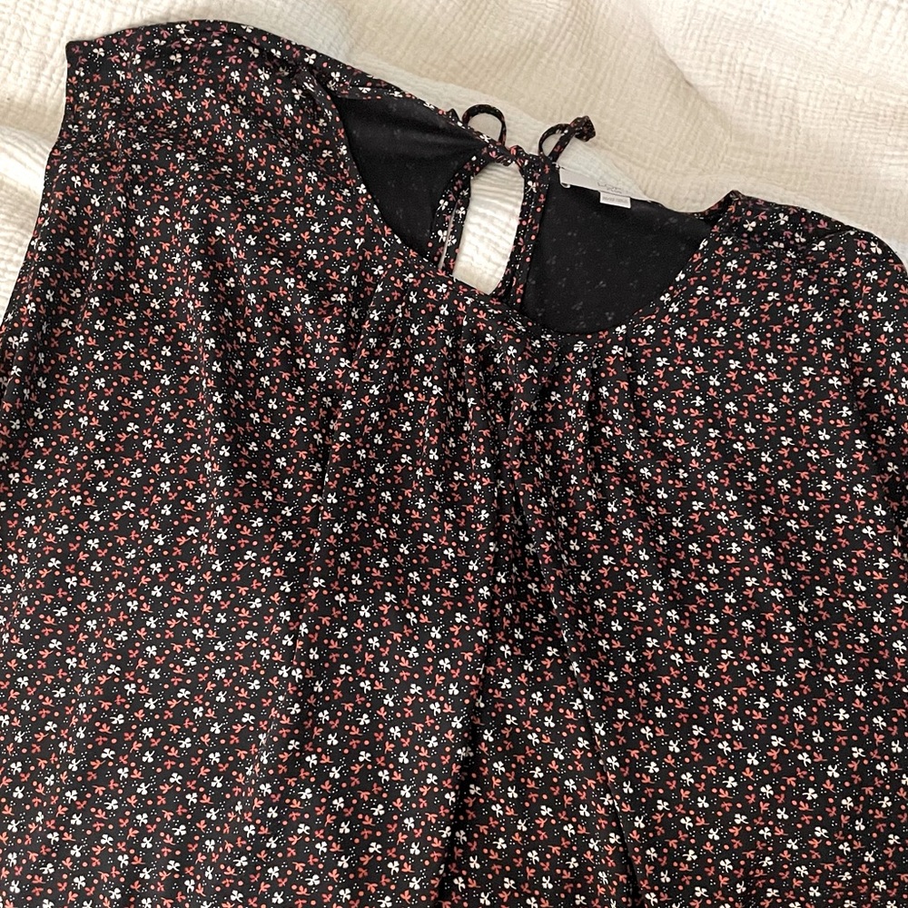 Flowy black top with floral details